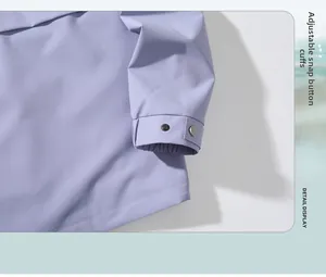 Detail view of adjustable snap button cuffs on a light purple outdoor windbreaker jacket