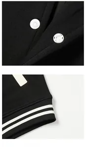 Detail of white snap buttons and black and white striped ribbed hem on casual jacket