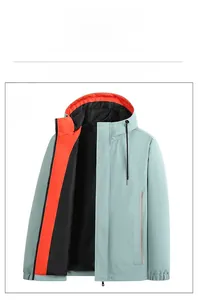 Detail view of water-resistant green jacket with vibrant orange and black inner lining