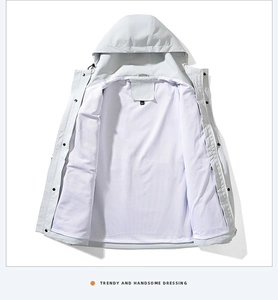 Detail of light gray windbreaker with breathable white mesh lining and snap closure