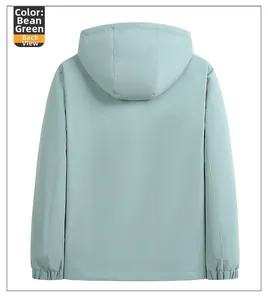 Detail view of the back of a light bean green windbreaker jacket with elastic cuffs and hem