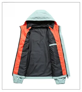 Detailed interior of the sage green windbreaker showing black lining and orange trim