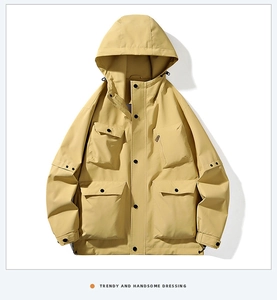 Detail of khaki windproof outdoor jacket with four large utility pockets and adjustable cuffs