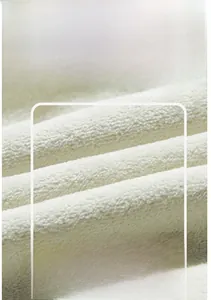 Macro view of creamy white fleece lining showing soft thermal insulation texture