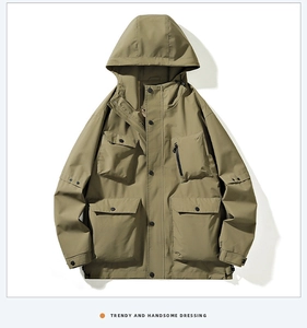 Detail of khaki outdoor hooded jacket featuring functional 3D cargo pockets and dual zippers