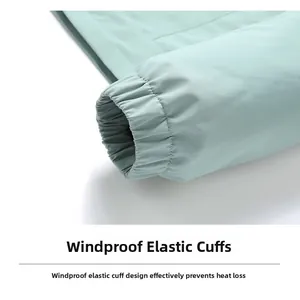 Detail of windproof elastic cuff on light green jacket with polyester fabric texture