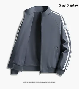 Detail of grey standing collar jacket featuring white sleeve stripes and apparel patch