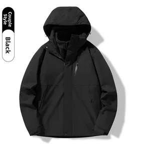 Detail of waterproof zipper and adjustable velcro cuff on black 3-in-1 outdoor jacket