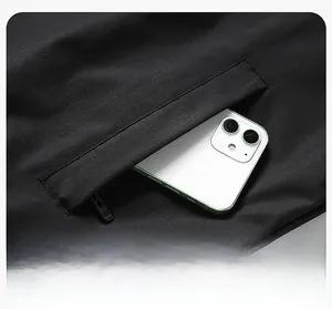 Detail of functional side pocket on black windproof jacket with hidden zipper for storage