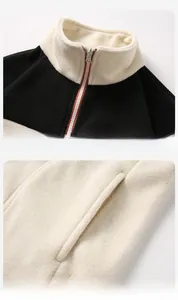 Detailed view of the stand-up collar and side pockets of a bicolor fleece jacket