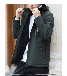 Detail of dark green hooded jacket featuring thick black fleece lining and arm shield logo