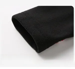 Detail shot of black fleece jacket cuff showing premium windproof and warm fabric texture