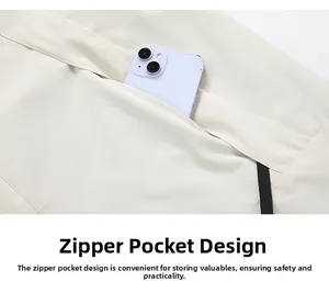 Detail view of the large capacity zipper pocket on a beige outdoor functional jacket