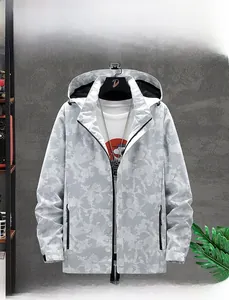 Detail of outdoor storm jacket featuring grey camouflage print and detachable hood