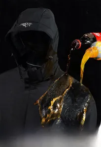Close-up of black waterproof jacket showing anti-stain technology with liquid splashing