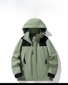 Detail of outdoor jacket showing light green fabric, black panels, and velcro cuffs