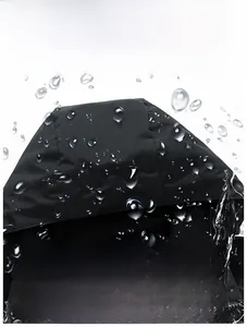 Detail of waterproof hood with water droplets on black outdoor technical jacket