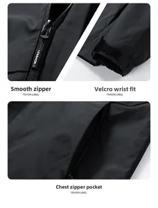 Detail view of the smooth zipper, velcro cuffs, and zippered chest pocket on black jacket