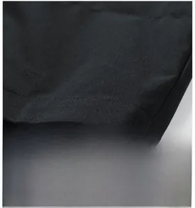 Macro shot of scratch-resistant tech fabric with durable stitching for outdoor jackets