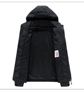 Detail shot of black hooded jacket featuring tropical leaf print and mesh lining