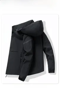 Detail view of black hooded jacket with elastic cuffs and a waterproof surface