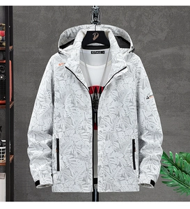 Detailed view of men's windbreaker featuring tropical leaf print and hooded drawstring design