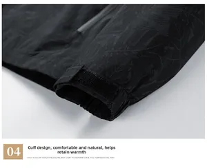 Detail of adjustable velcro cuff on a black windproof jacket with leaf pattern print