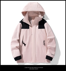 Detail view of the pink and black outdoor jacket showing adjustable velcro cuffs and logo