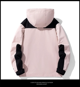 Detail of pink and black hooded outdoor jacket featuring windproof polyester fabric