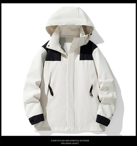 Detail view of water-resistant hooded jacket featuring cream and black contrast design