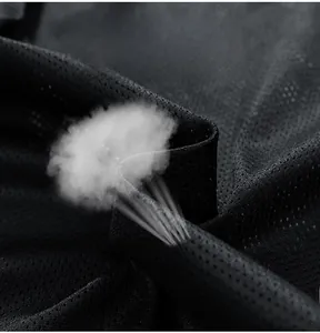 Detail of black mesh fabric showing high breathability with smoke effect demonstration