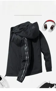 Close-up of black hooded jacket featuring reflective sleeve stripes and logo detail