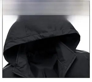 Close-up of black windproof hooded jacket featuring peak logo and mountain text print