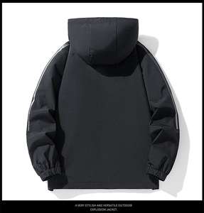 Detail view of black outdoor jacket with reflective stripes and elastic cuffs on white background