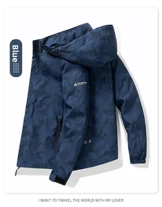 Detail of blue camouflage windproof jacket with adjustable cuffs and logo patch