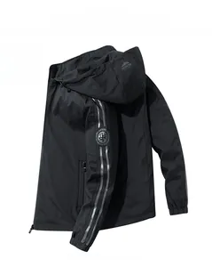 Detail of black hooded windbreaker jacket featuring reflective sleeve stripes and zip pockets