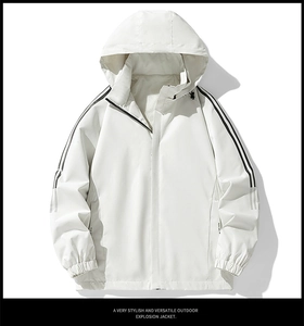 Detail of white hooded jacket featuring black stripes on sleeves and elastic cuffs