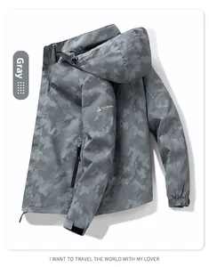 Detail of grey digital camo windbreaker with velcro cuff and orange zipper accents
