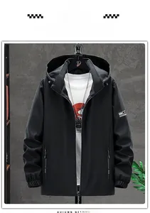 Detail of a black hooded windbreaker featuring zip pockets and elasticated cuffs