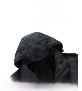 Detail of hooded jacket showing honeycomb mesh texture and dark camo pattern fabric