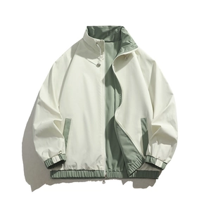 Unisex reversible windbreaker jacket in beige and green featuring stand collar and elastic cuffs