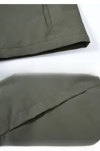 Detail of army green outdoor vest showing reinforced stitching on the collar and back