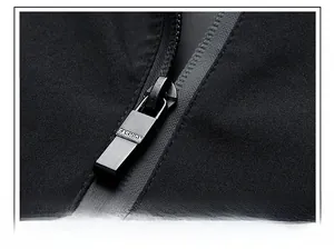 Close-up of matte black metal zipper with FASHION engraving on men's casual jacket