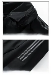 Detail of black sports jacket featuring detachable hood and triple grey sleeve stripes