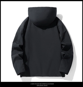 Rear view of a black waterproof outdoor hooded jacket with a minimalist urban design