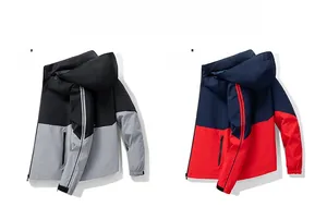 Flat lay of color-block windbreaker jackets with striped sleeves and detachable hoods