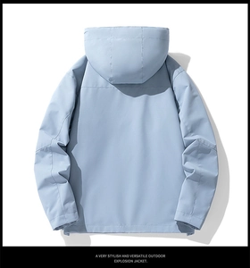Rear view of a light blue waterproof outdoor jacket with integrated hood and sleek design