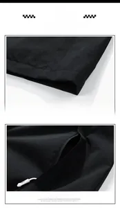 Detail view of water-resistant outdoor jacket showing clean hem and hidden zipper pocket