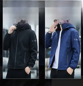 Detail of hooded windproof jacket with elastic cuffs and zipper closure in black and blue