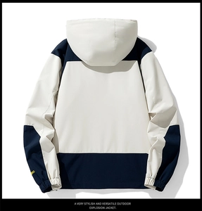 Detail of color-block outdoor jacket showing sleeve embroidery and elastic cuffs